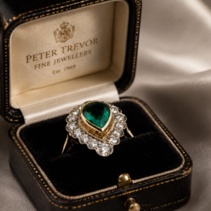 Pear Shaped Emerald with diamond halo ring